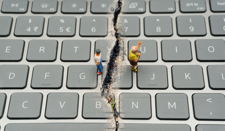 Internet Confrontation.digital divide.The keyboard is split by the cracks that separate the opposites.Social Divide.Divided world.conflicts.cyberbullying.