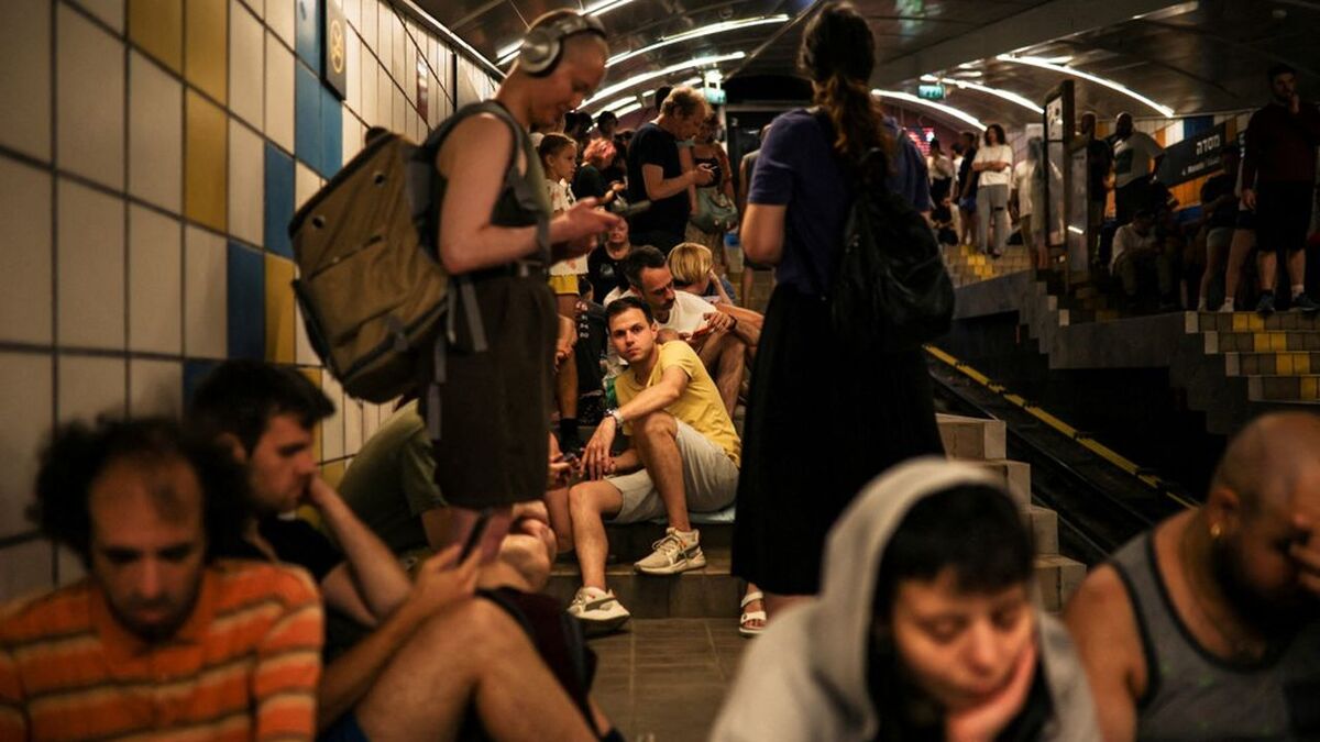 People take cover inside a cable car tunnel following a missile attack from Iran on Israel, at Haifa, Israel June 17, 2025. REUTERS/Shir Torem